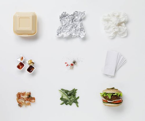 a hamburger aligned with all its associated waste - junk food stock pictures, royalty-free photos & images