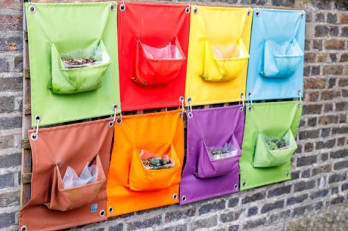 a hanging garden on a wall - garden decoration stock pictures, royalty-free photos & images