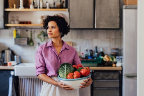 a happy beautiful woman holding a bowl of organic healthy vegeta - food stock pictures, royalty-free photos & images