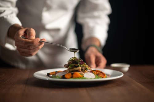 a male chef pouring sauce on meal - food stock pictures, royalty-free photos & images