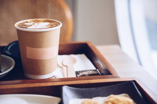 a paper cup containing hot coffee in coffee shop. - junk food stock pictures, royalty-free photos & images