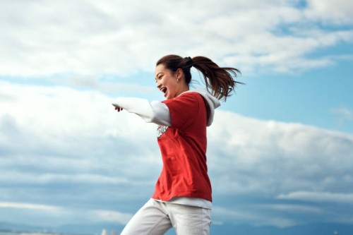 a person who dances against the blue sky. - fashion stock pictures, royalty-free photos & images