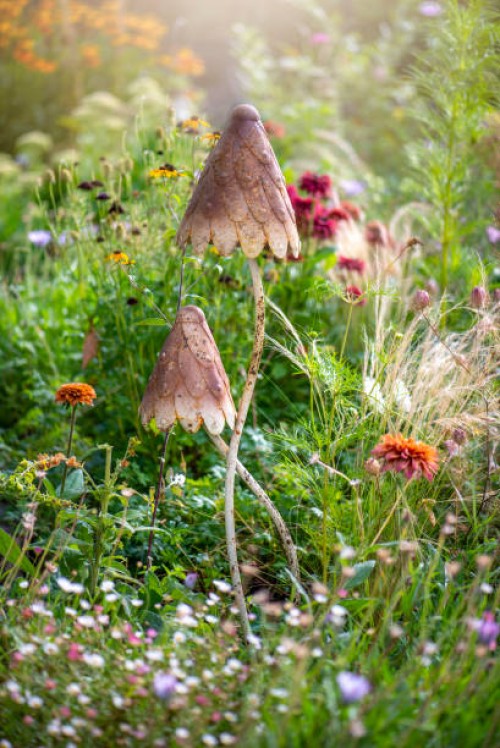a pretty garden feature of two metal brown mushrooms in an english country garden - garden decoration stock pictures, royalty-free photos & images