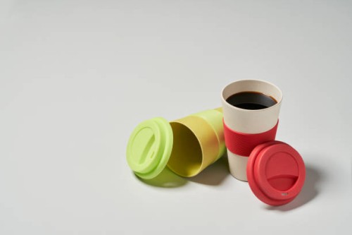 a reusable coffee cup placed on a gray background - junk food stock pictures, royalty-free photos & images