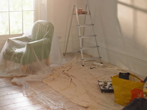a room with dust sheets, a ladder and paint roller - home decoration stock pictures, royalty-free photos & images