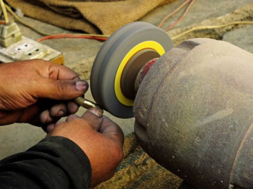 a senior worker is applying polish on a piece of handicraft - home decoration stock pictures, royalty-free photos & images