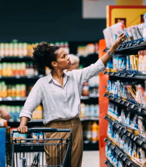 a serious beautiful cuban woman shopping at the supermarket - food stock pictures, royalty-free photos & images