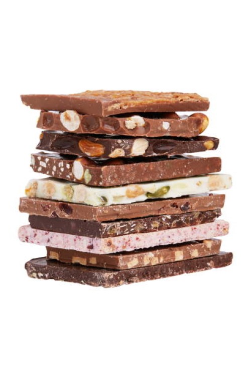 a stack of different chocolate isolated on white background - junk food stock pictures, royalty-free photos & images