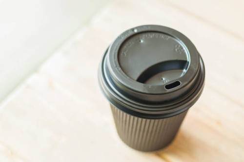 a still life of black disposable coffee cup - junk food stock pictures, royalty-free photos & images