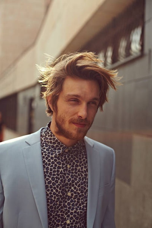 a trendy man walking city streets - fashion stock pictures, royalty-free photos & images
