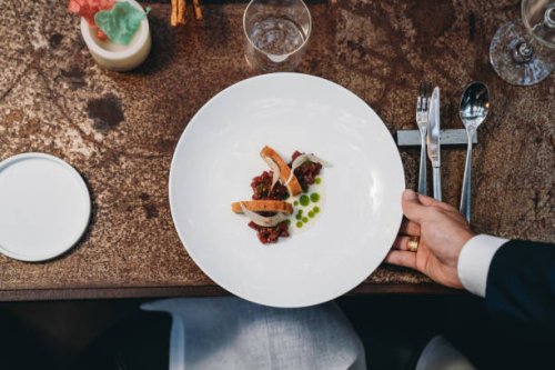 a waiter is serving a plate in an high-end restaurant - food stock pictures, royalty-free photos & images