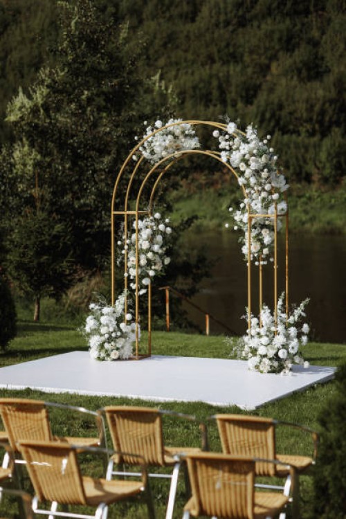 a wedding ceremony is taking place in a park with a beautiful archway - garden decoration stock pictures, royalty-free photos & images
