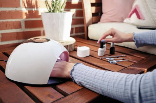 a woman applies a treatment to paint her fingernails - nails art stock pictures, royalty-free photos & images