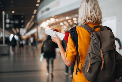 a woman at the airport holding a passport with a boarding pass - travel stock pictures, royalty-free photos & images