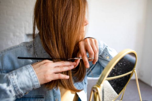 a woman cutting her own hair - hairstyle stock pictures, royalty-free photos & images