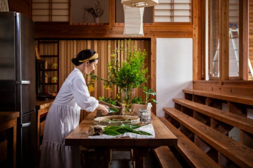 a woman cutting herbs and vegetables in the kitchen. - home decoration stock pictures, royalty-free photos & images
