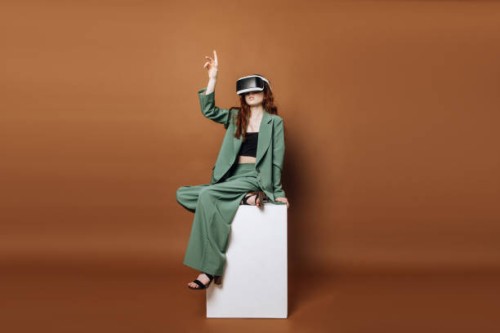 a woman in vertacular reality glasses sits and plays games on a colored background. concept technology and vertical reality. - fashion stock pictures, royalty-free photos & images