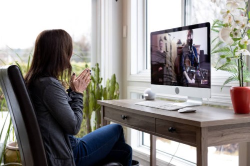 a woman is watching an online music concert from home for her birthday during covid-19 pandemic - concert stock pictures, royalty-free photos & images