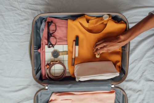 a woman packing her clothes in a suitcase - travel stock pictures, royalty-free photos & images