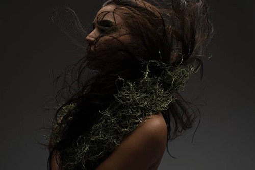 a woman wearing a moss necklace - fashion stock pictures, royalty-free photos & images