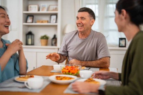 a young asian family is having takeaway pizza at home and enjoying dinner together. concept of love and unity. - junk food stock pictures, royalty-free photos & images