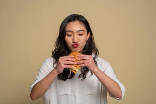 a young asian girl is eating - food stock pictures, royalty-free photos & images