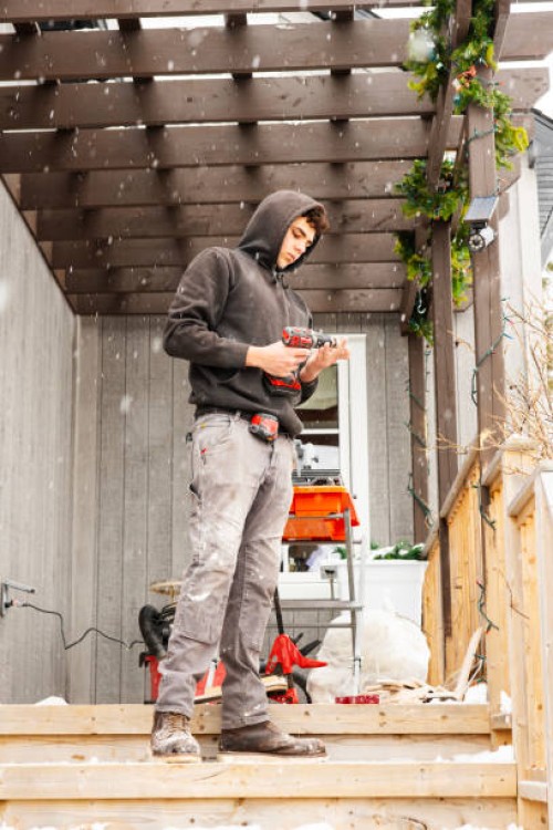 a young construction worker outside of a residential house working - home decoration stock pictures, royalty-free photos & images