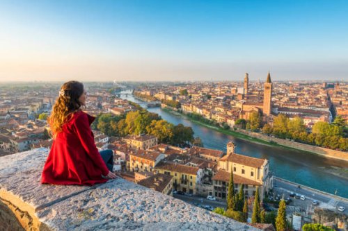 a young woman admires the view of verona old town from castel san pietro - travel stock pictures, royalty-free photos & images