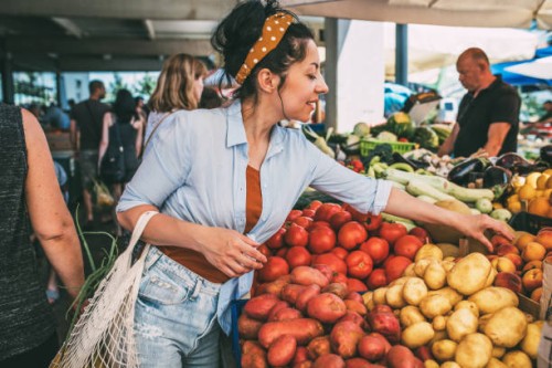 a young woman buys vegetables and fruits at the market . - food stock pictures, royalty-free photos & images