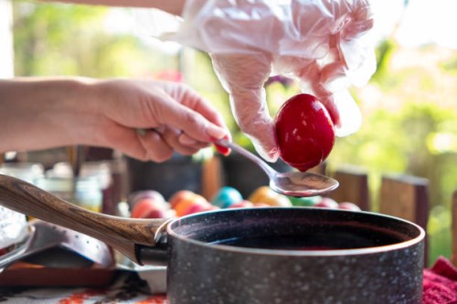 a young woman paints eggs for easter in a cottage in the forest. - garden decoration stock pictures, royalty-free photos & images