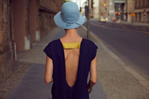 a young woman walking through the city - fashion stock pictures, royalty-free photos & images