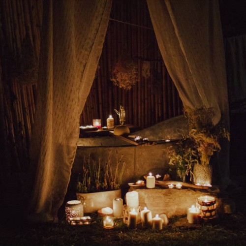 a zinc bathtub in the garden. lots of candles around it. - garden decoration stock pictures, royalty-free photos & images