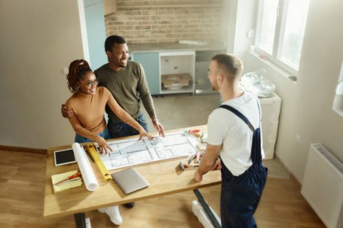 above view of happy black couple talking about plans with their manual worker. - home decoration stock pictures, royalty-free photos & images