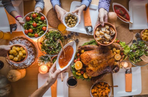 above view of passing food during thanksgiving dinner. - food stock pictures, royalty-free photos & images