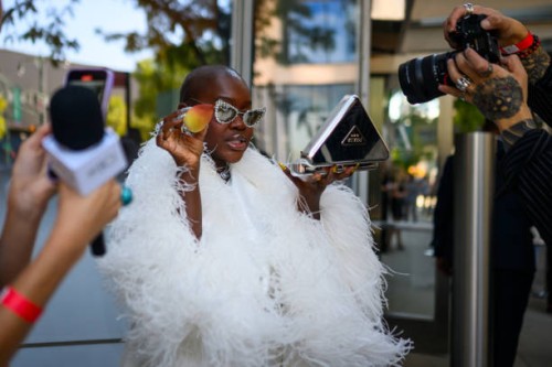 Achieng Agutu poses with her Prada make up kit and beauty blender outside the Pat Bo show during the New York Fashion week Spring/Summer 2025 on...