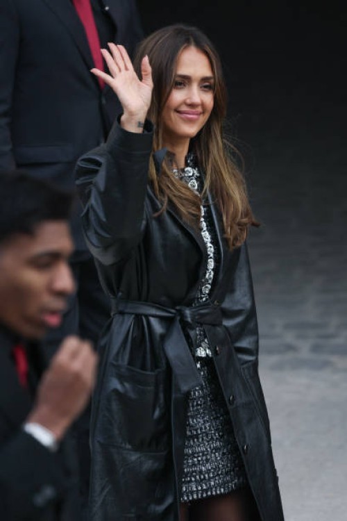 Actress Jessica Alba waves as she arrives to attend the presentation by Chanel for the Womenswear Ready-to-wear Fall-Winter 2025/2026 collection as...