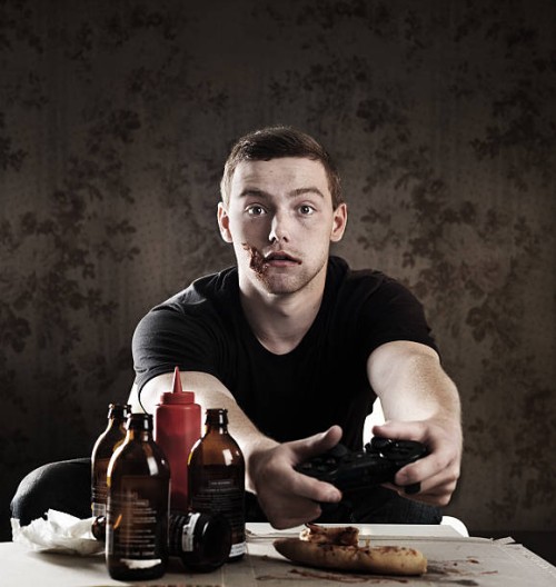 addicted gamer - junk food stockfoto's en -beelden
