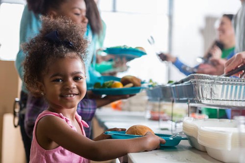 adorable little girl in soup kitchen - food stock pictures, royalty-free photos & images