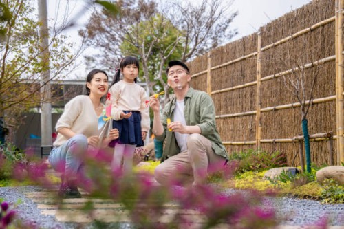 adorable little girl playing soap bubbles with her mother and father outdoors. - garden decoration stock pictures, royalty-free photos & images