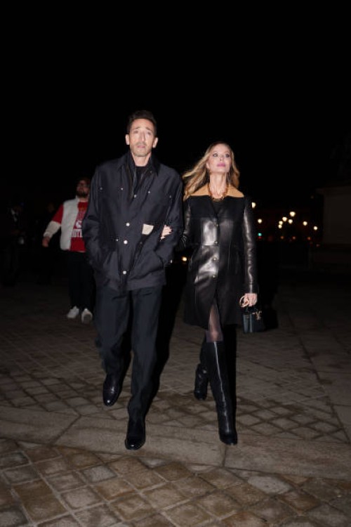 Adrien Brody wears a black jacket , black pants ; Georgina Chapman wears a black leather leather coat worn as a dress, knee high boots, before the...