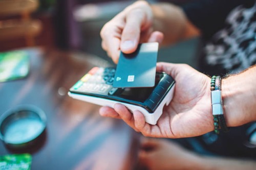 adult man paying with credit card at cafe, close-up of hands with credit card and credit card reader - food stock pictures, royalty-free photos & images