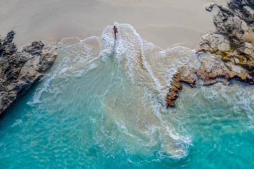 aerial view of a woman walking out of the water_little exuma_exuma_bahamas - travel photos et images de collection