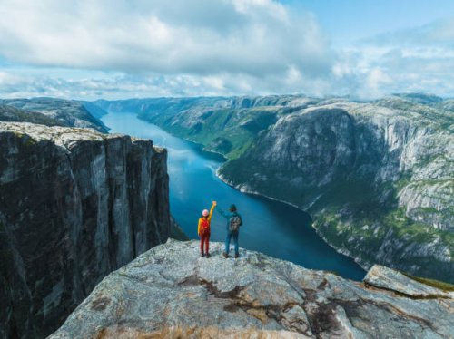 aerial view of man and woman raising holding arms in mountains in norway - travel stock pictures, royalty-free photos & images