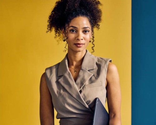 african american businesswoman looking at the camera. indoor casual portrait with yellow, blue, and white background. professional and confident concept. - fashion stock pictures, royalty-free photos & images
