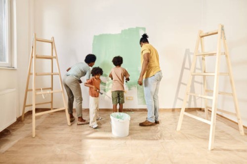 african american family painting walls in their apartment. - home decoration stock pictures, royalty-free photos & images