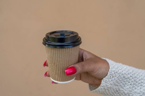 african american woman's hands holding a paper cup coffee - junk food stock pictures, royalty-free photos & images