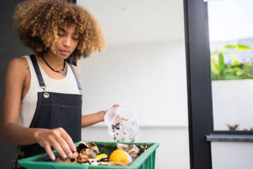 african american young woman making compost from leftovers. sustainability concept. - food stock pictures, royalty-free photos & images