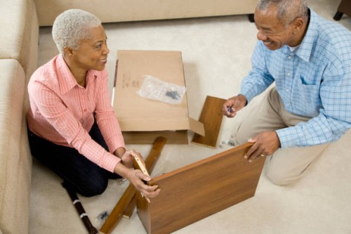 african couple assembling shelf - home decoration stock pictures, royalty-free photos & images