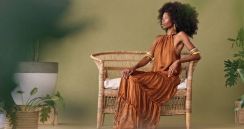 african, fashion and black woman in tropical studio design to model interior design, furniture and plants on green background. afro woman sitting on chair mockup for beauty, natural skin and wellness - fashion stock pictures,