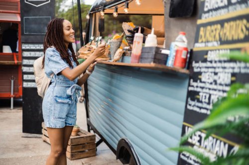 afro girl buying potato at the fast food truck - food stock pictures, royalty-free photos & images